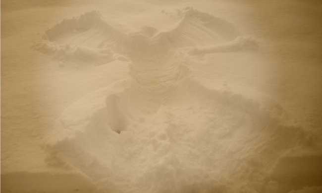 image capturing a snow angel with a brown filter applied to the entire image